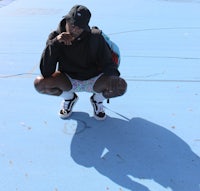 a man crouching down on a skateboard