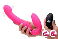 a hand holding a pink vibrating toy with a remote control