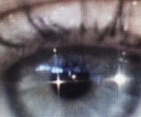 a close up of a person's eye with stars in it