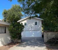a house with two garages and a driveway
