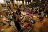 a group of people are sitting in a large room
