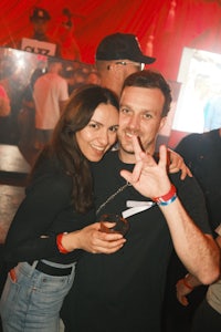 a man and woman posing for a photo at a party