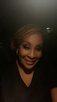 a woman in a black shirt smiling at the camera