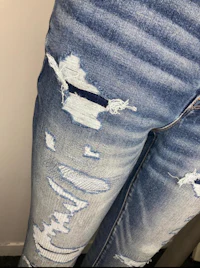 a close up of a woman's jeans with holes in them