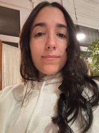 a woman with long hair sitting in a chair