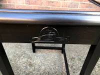 a black side table with a glass top