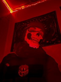a person wearing a black jacket with a skull on it