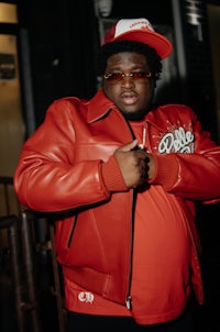 a man wearing a red leather jacket