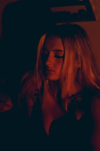 a woman looking at her phone in the dark