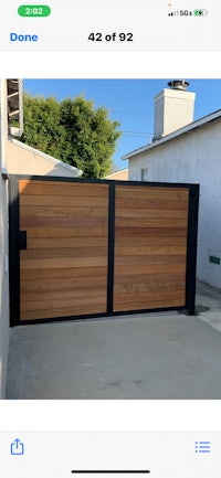a photo of a wooden gate in a backyard
