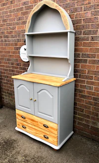 a grey hutch with a wooden top