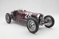 a model of a vintage racing car on a white background