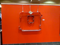 a cookie cutter hanging on a red wall