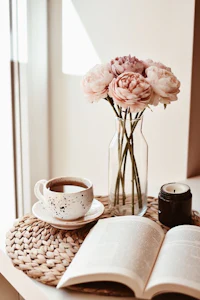 a cup of coffee and a book on a table