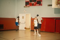 a group of men playing basketball in a gym
