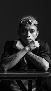 a black and white photo of a man sitting at a table