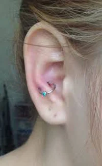 a girl with a blue ear piercing