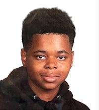 a photo of a young man wearing a black hoodie