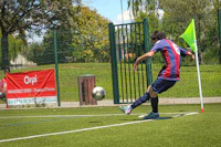 a man is kicking a soccer ball