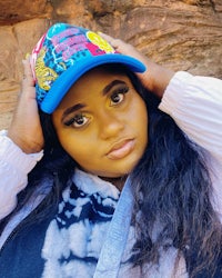a young woman wearing a blue hat