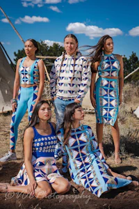 a group of native american women posing in front of a tent