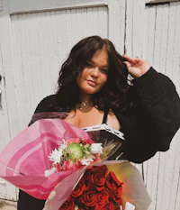 a woman holding a bouquet of roses