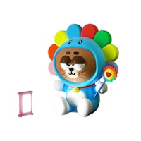 a toy bear with a flower on his head