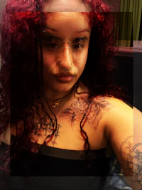 a woman with red hair and tattoos