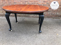 a table with a round top and black legs