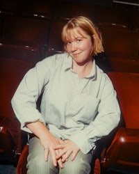 a woman sitting in an auditorium