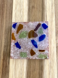 a piece of sea glass on a wooden surface