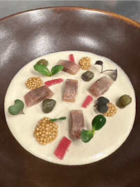 a bowl of soup with tuna and other ingredients