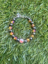 a bracelet with a pepsi logo on it