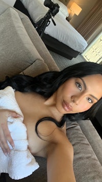 a woman laying on a couch with a towel