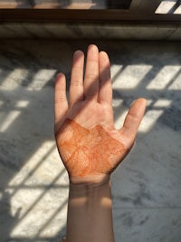 a person's hand with henna on it