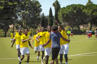 a group of men playing soccer on a field