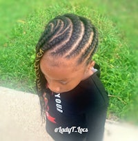 a little girl with braids on her head