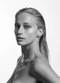 a black and white photo of a woman in a bikini