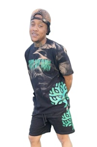 a man wearing a black t - shirt and green shorts
