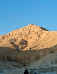 a man standing in front of a mountain in egypt