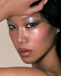 a woman with a pink and silver eye makeup