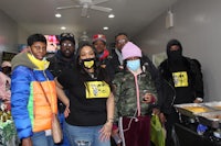 a group of people wearing face masks posing for a photo