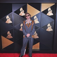 a man standing on the red carpet at the grammy awards