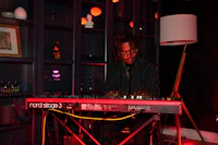 a man playing an electronic keyboard in a room
