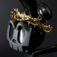 a black bunny wearing a crown of thorns