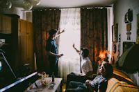 a group of people in a living room playing video games