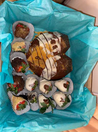 a box filled with a variety of desserts