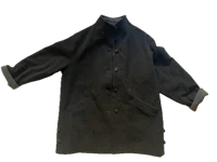 a black coat hanging on a black background