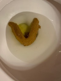 a toilet with a piece of bread in it