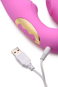 a pink and gold vibrator with a usb cable